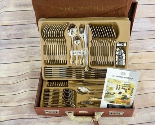 Gold Flatware set in an open suitcase with Carl weill branding