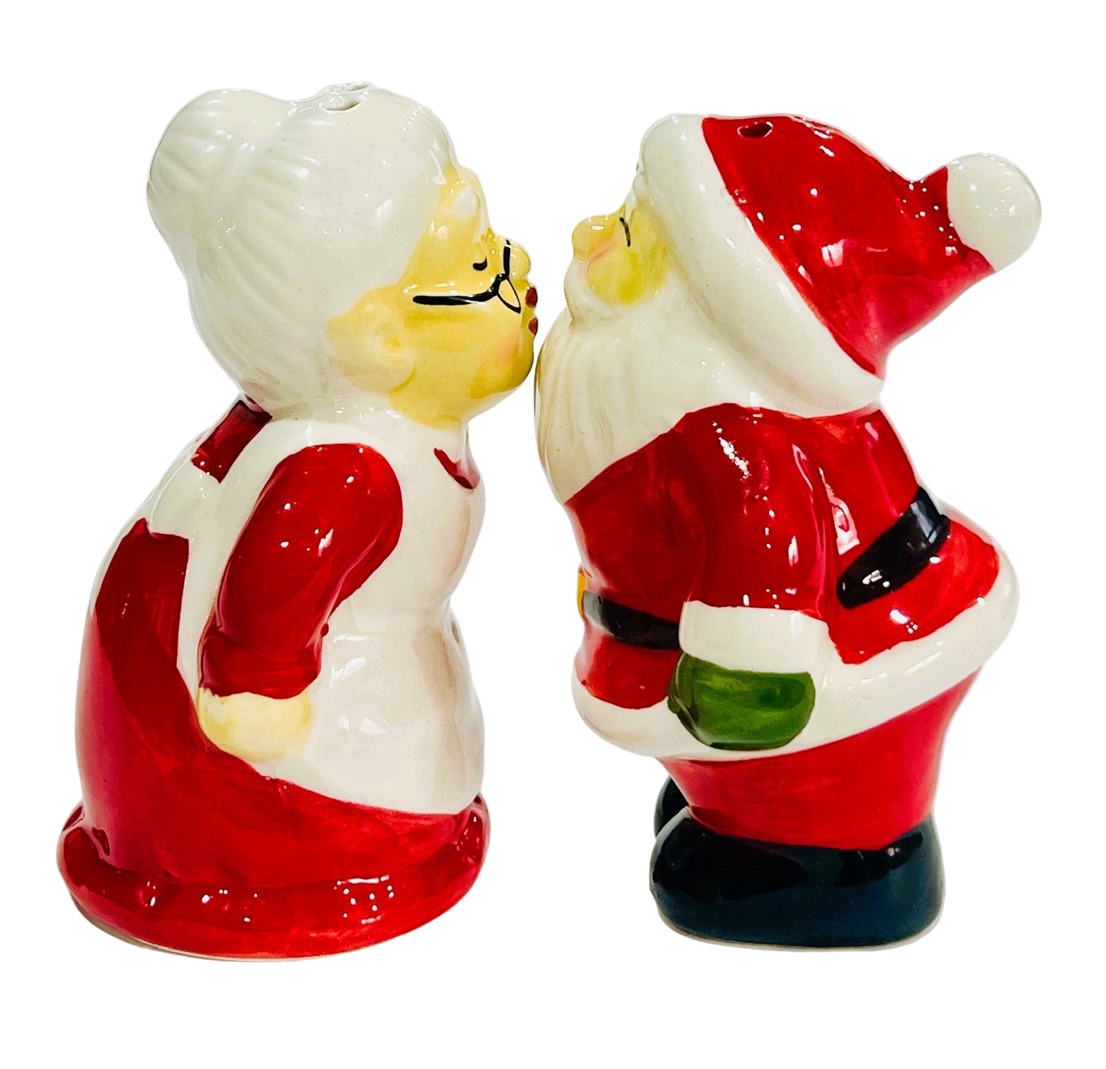 Salt and pepper shakers shaped like a Santa Claus and Mrs. Claus on a white background
