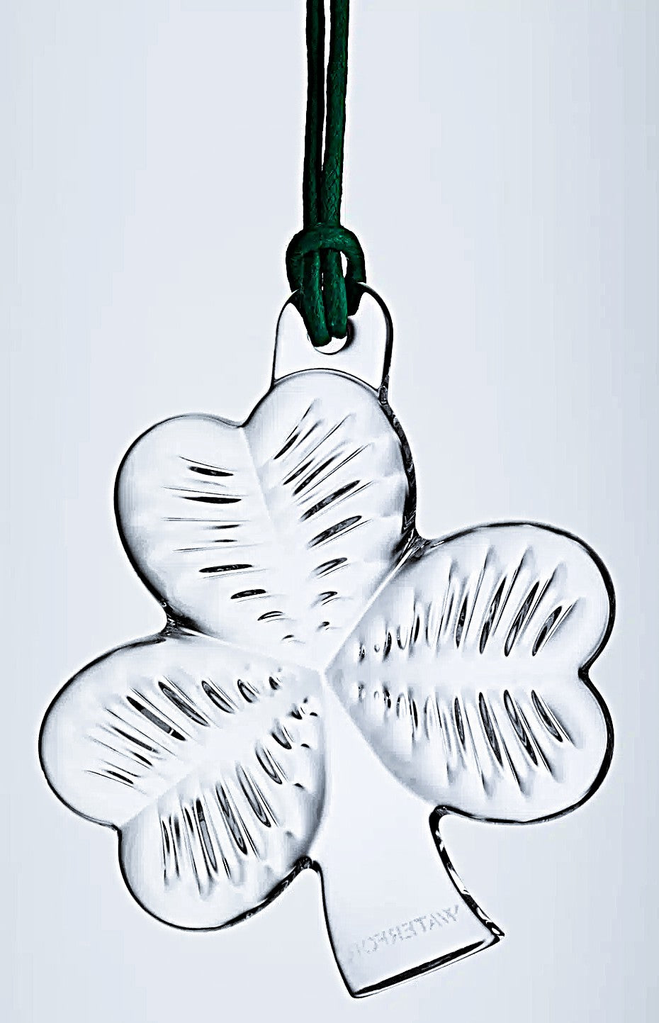 Clear glass four-leaf clover ornament with Waterford branding on a white background