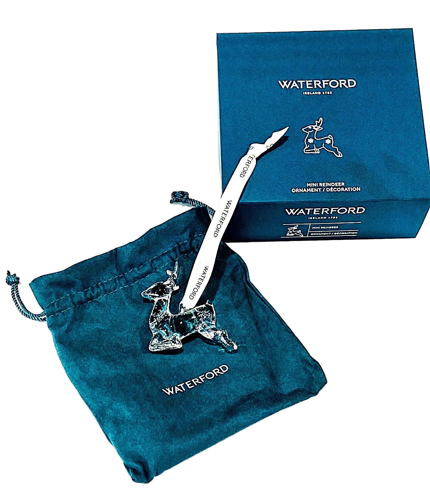Waterford crystal reindeer ornament with a blue drawstring bag and packaging box.