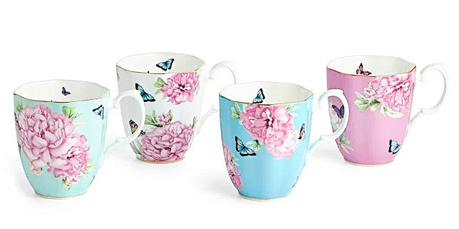 Set of four floral mugs with butterflies on a white background
