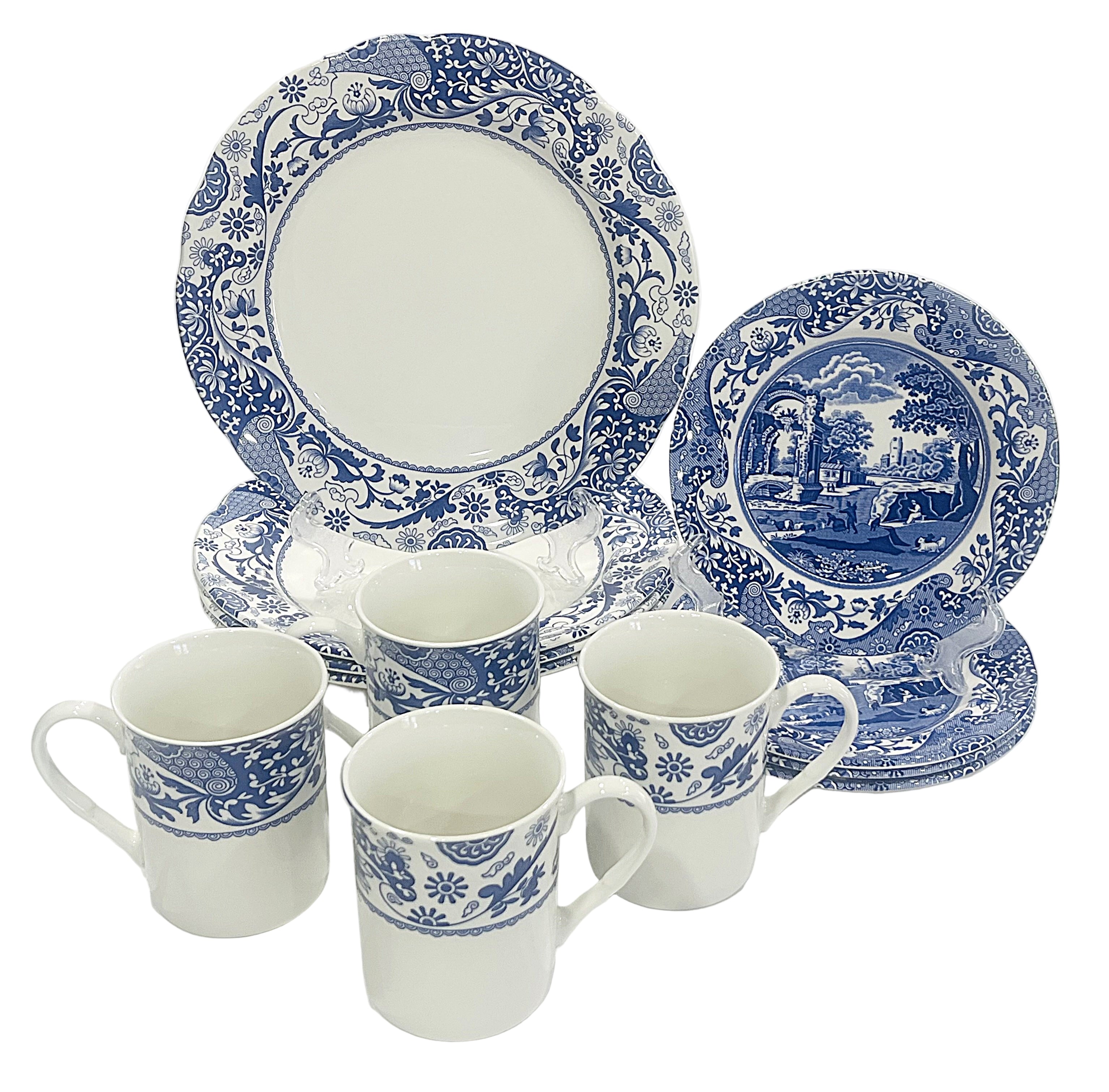 Set of blue and white ceramic dinnerware on a white background