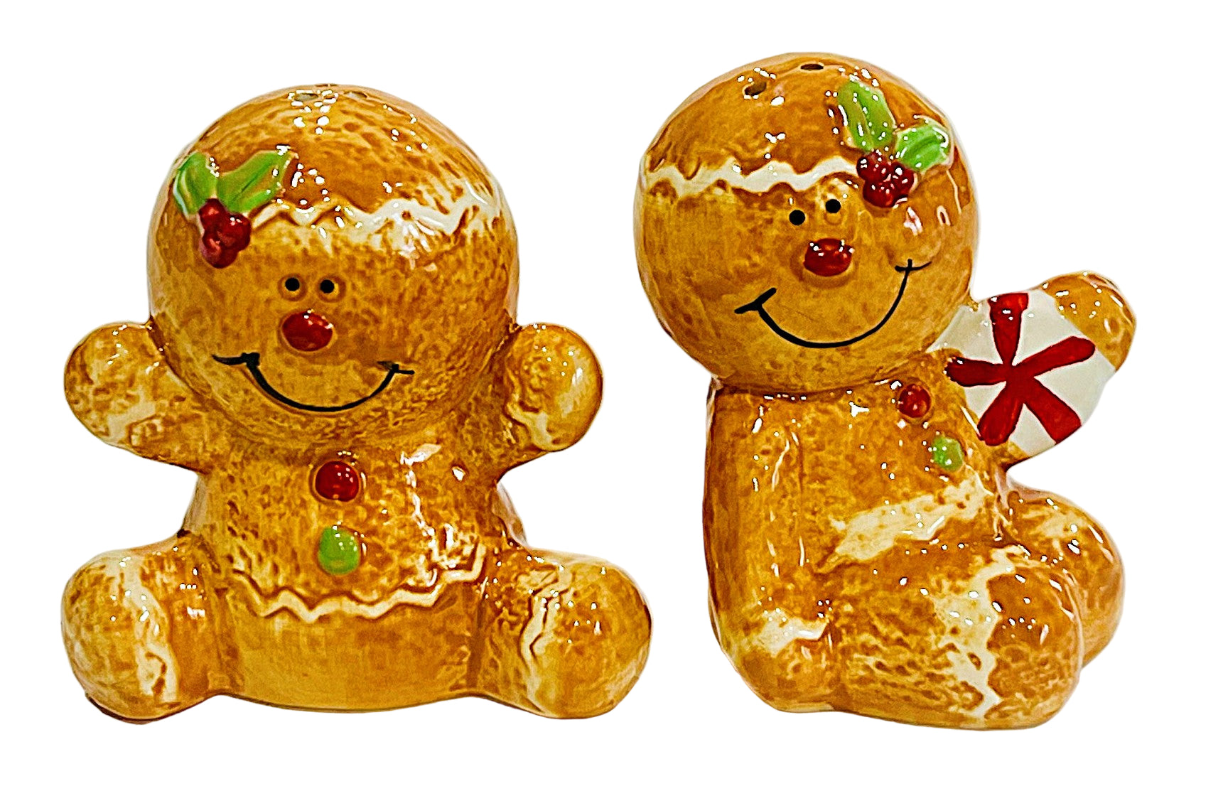 Two gingerbread man salt and pepper figurines with decorative elements