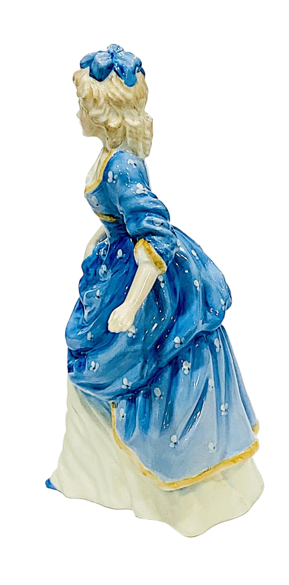Bone China figurine of a woman in a blue dress with a white background