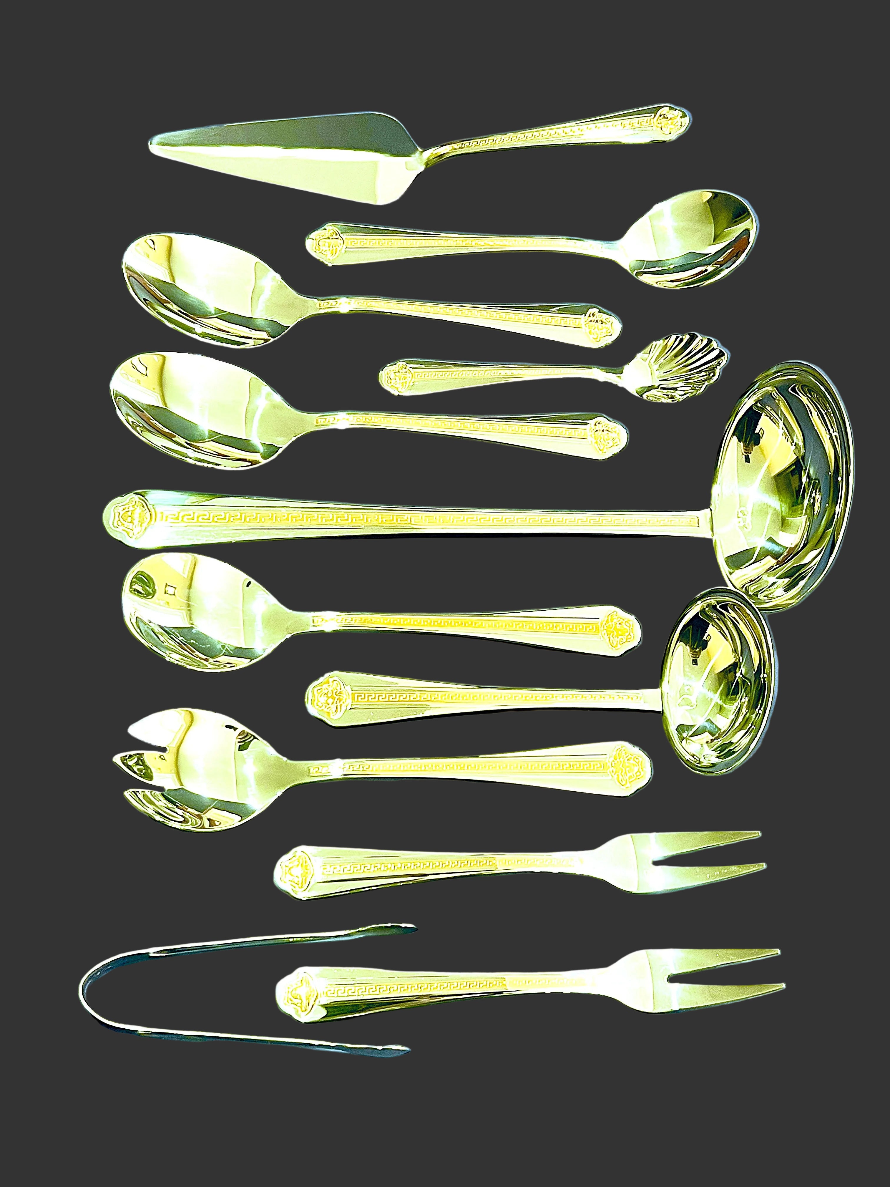 Set of gold-colored spoons and forks on a blue background