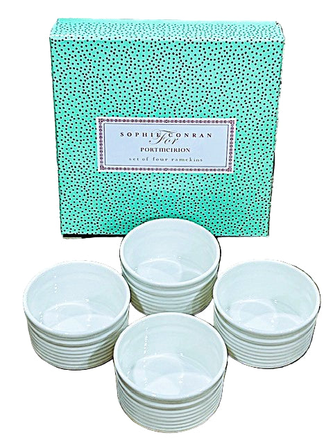 Set of white bowls with a Sophie Conran for Portmeirion box on a stone surface