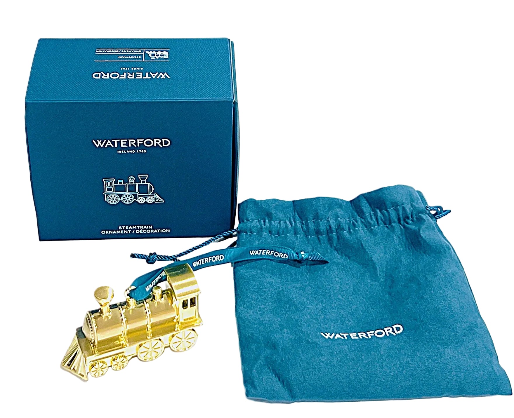 Golden train ornament with Waterford packaging on a white background