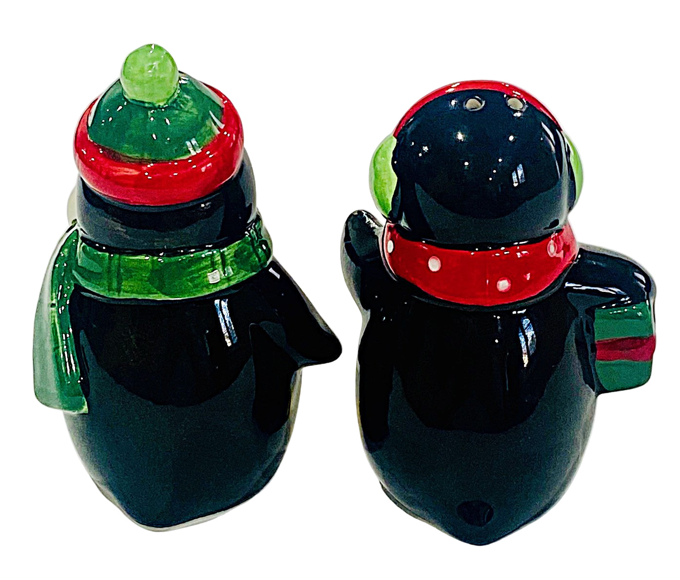 Two penguin-shaped salt and pepper shakers with colorful hats and scarves on a white background.
