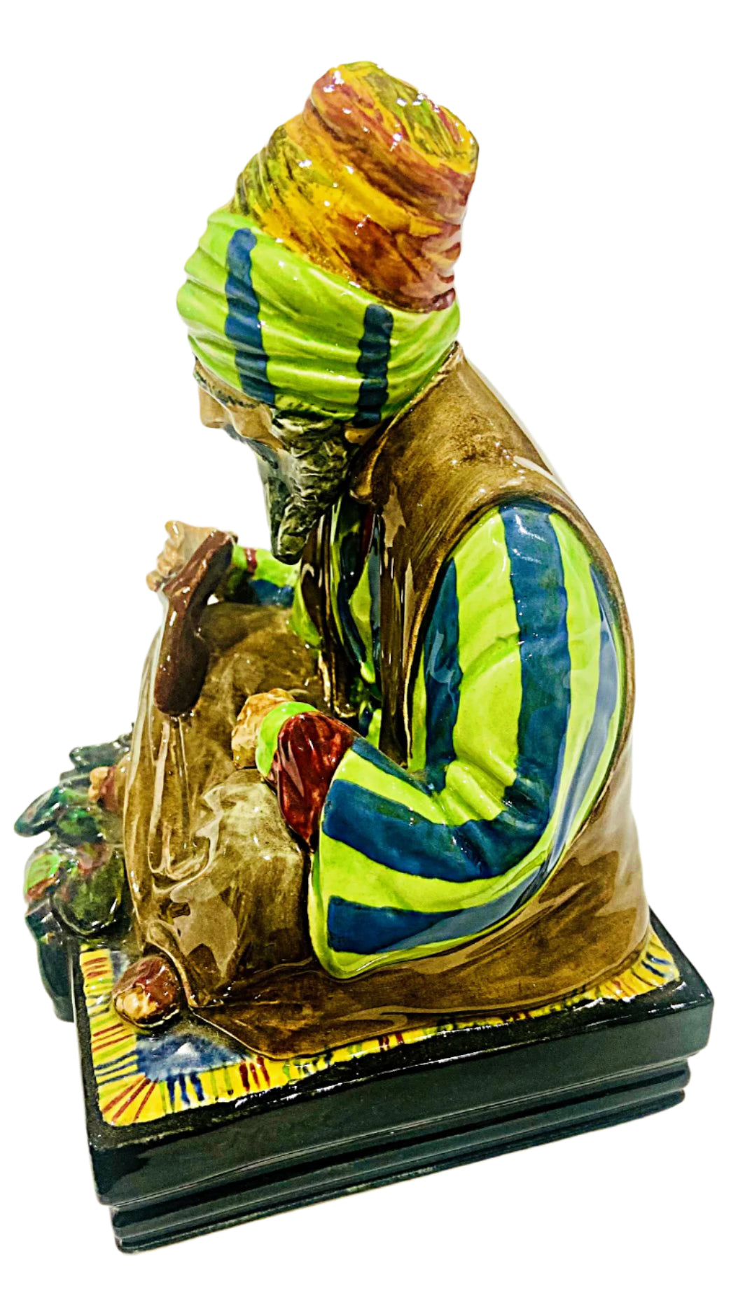 Colorful figurine of a man with a turban on a white background
