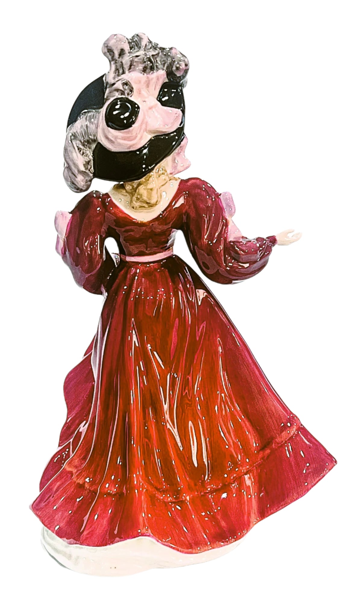 Decorative figurine of a woman in a red dress with a white background