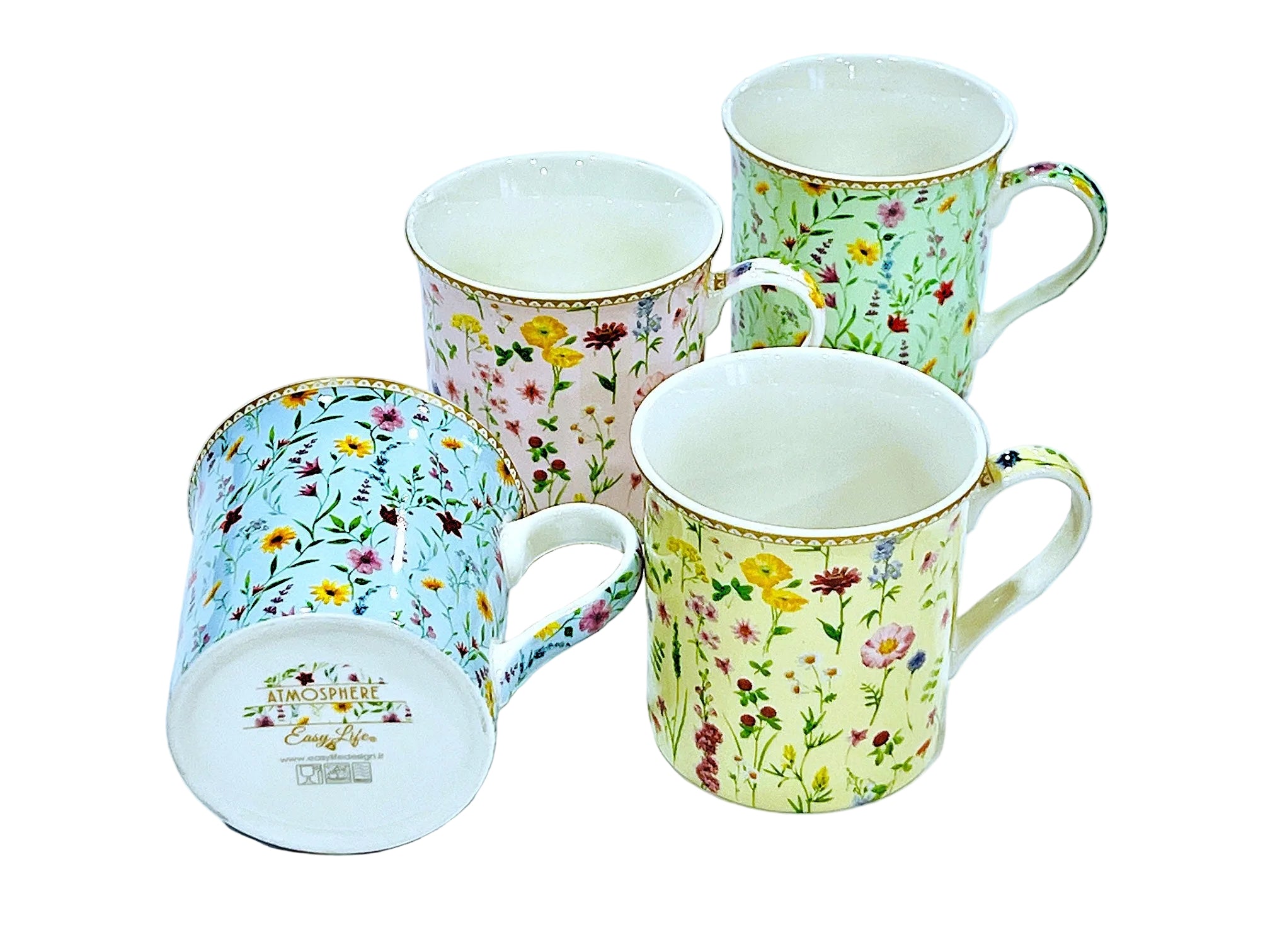 Set of four floral-patterned mugs on a light blue background