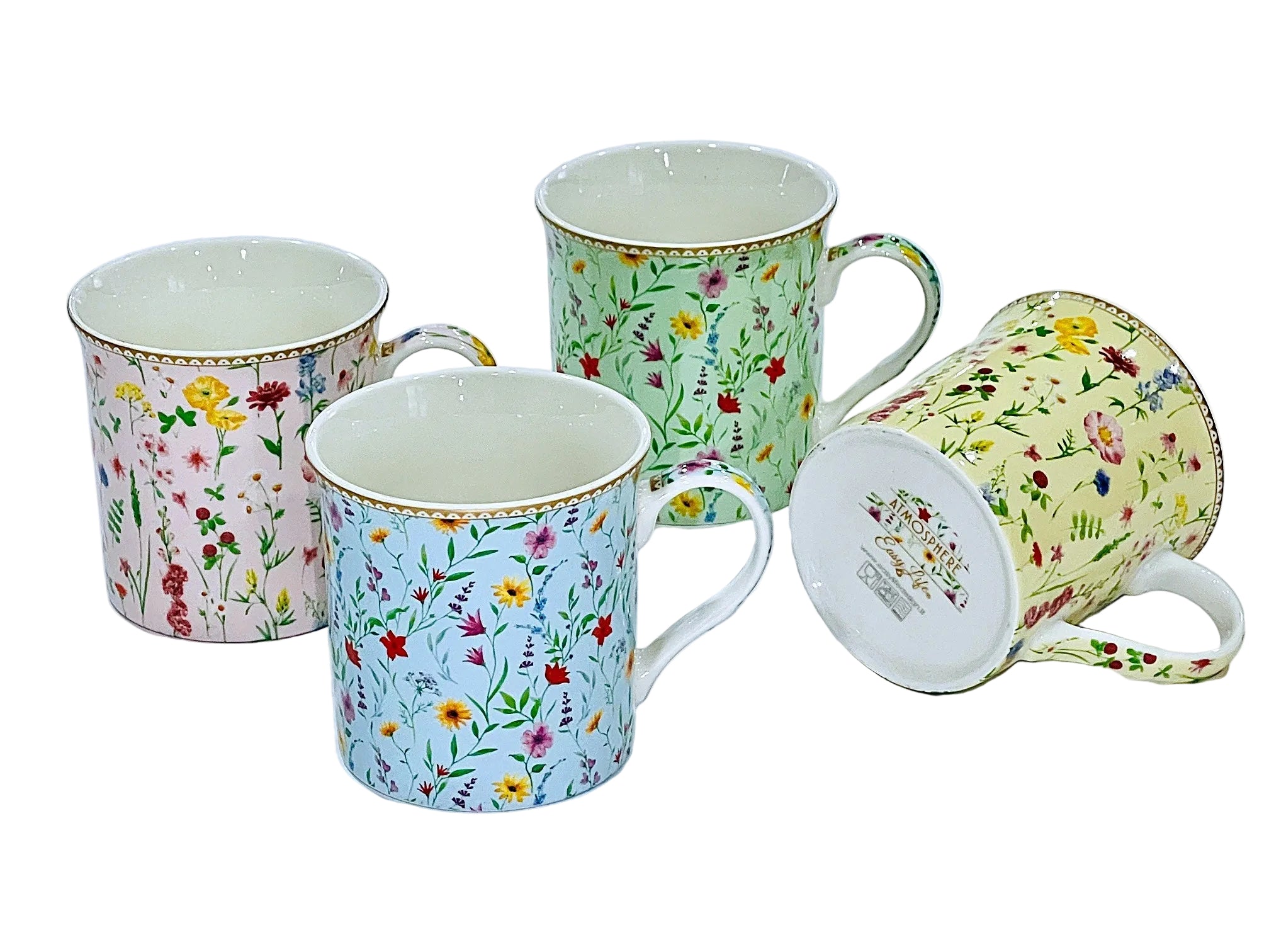 Four ceramic mugs with floral patterns on a white background