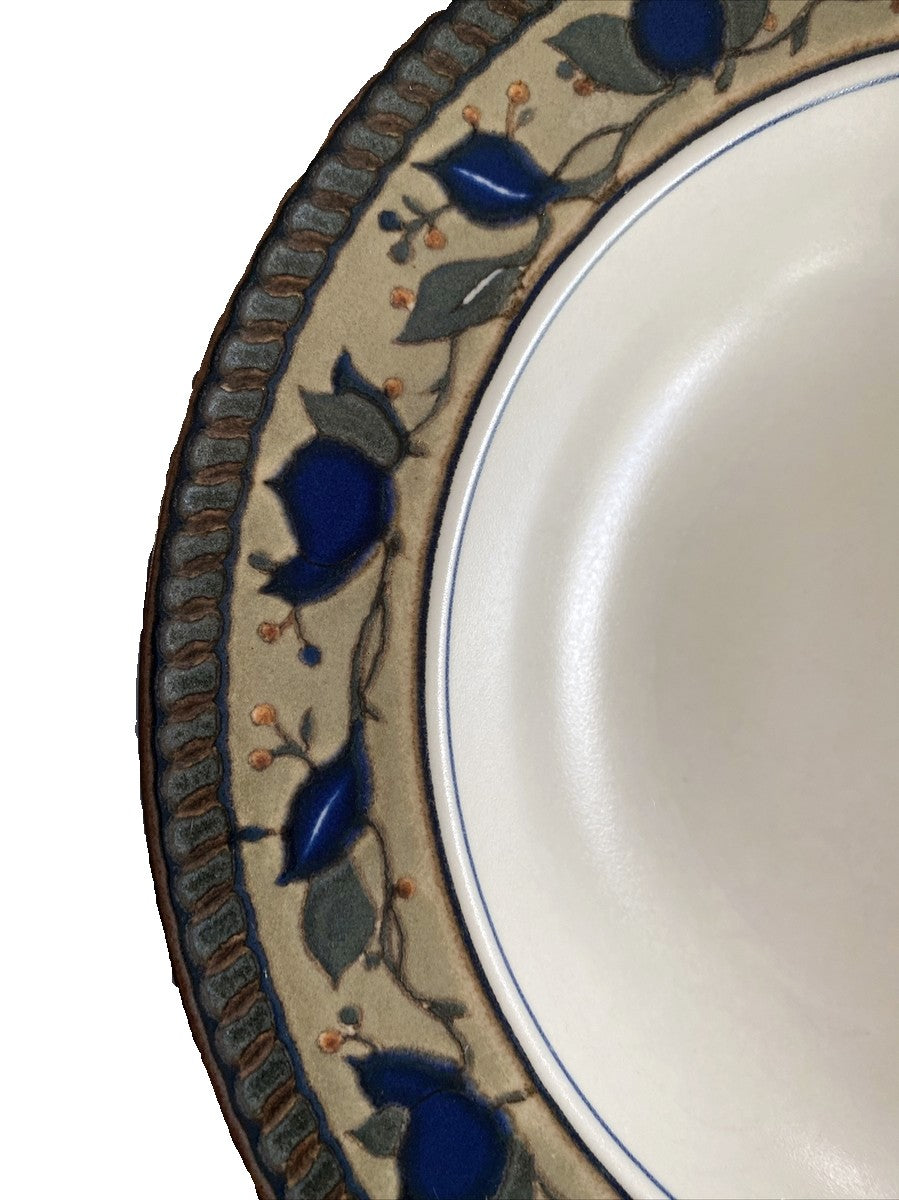 Mikasa Arabella Soup Bowl with a black leaf pattern on a white background Close-up of a ceramic late with decorative blue floral pattern
