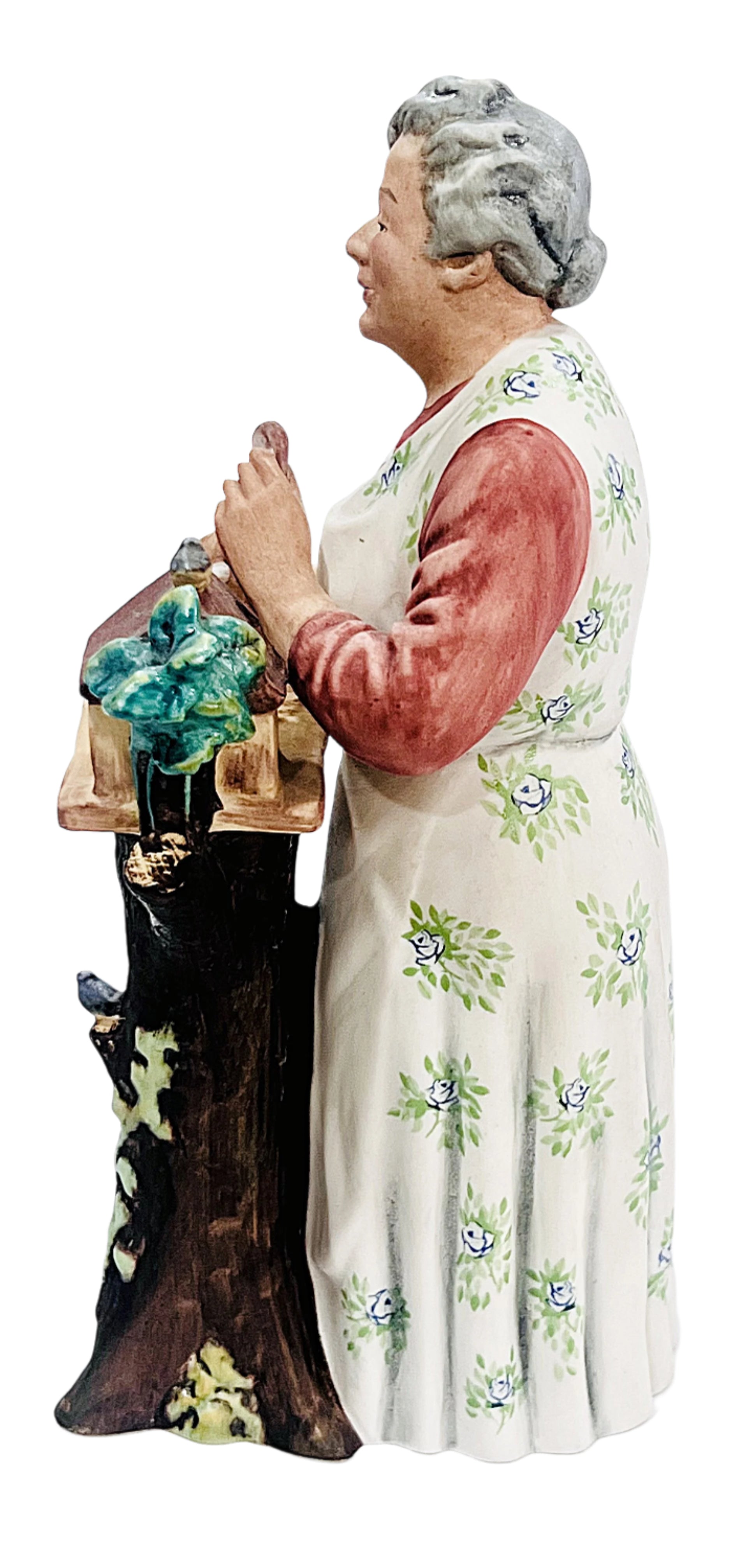 Vase-shaped figurine of a woman holding flowers on a white background
