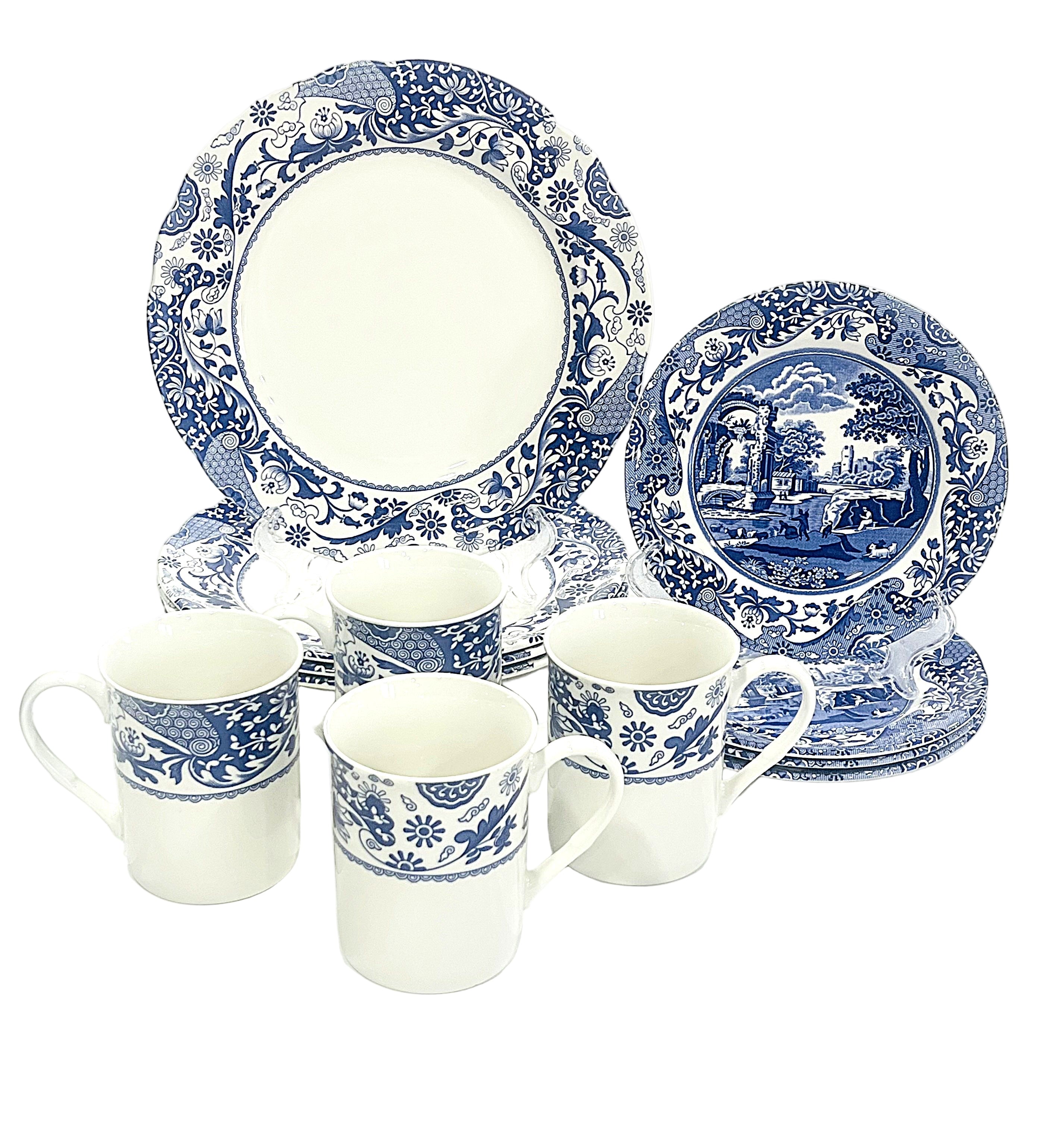 Set of blue and white ceramic dinnerware on a white background