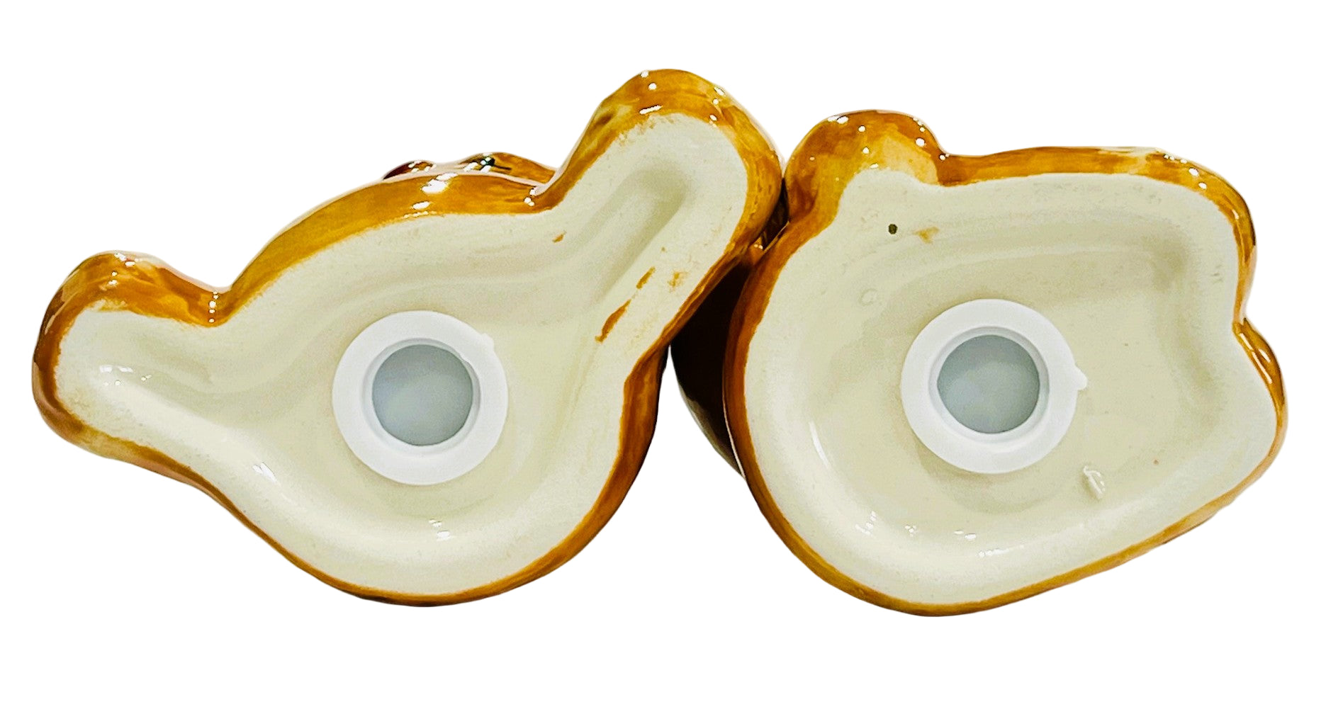 Two ceramic salt and pepper base with a white interior and gold exterior