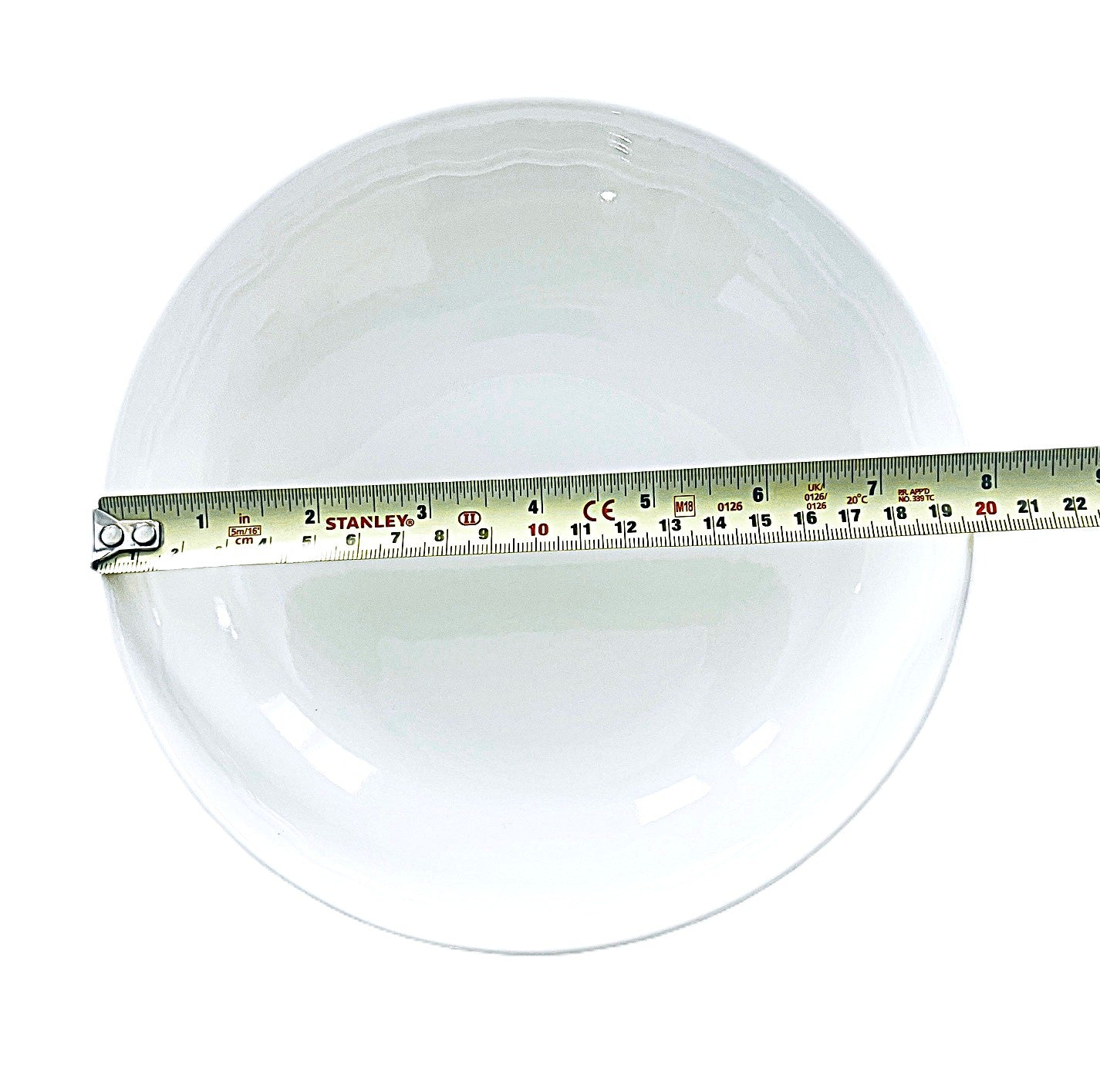 white soup bowl with a measuring tape on a white background