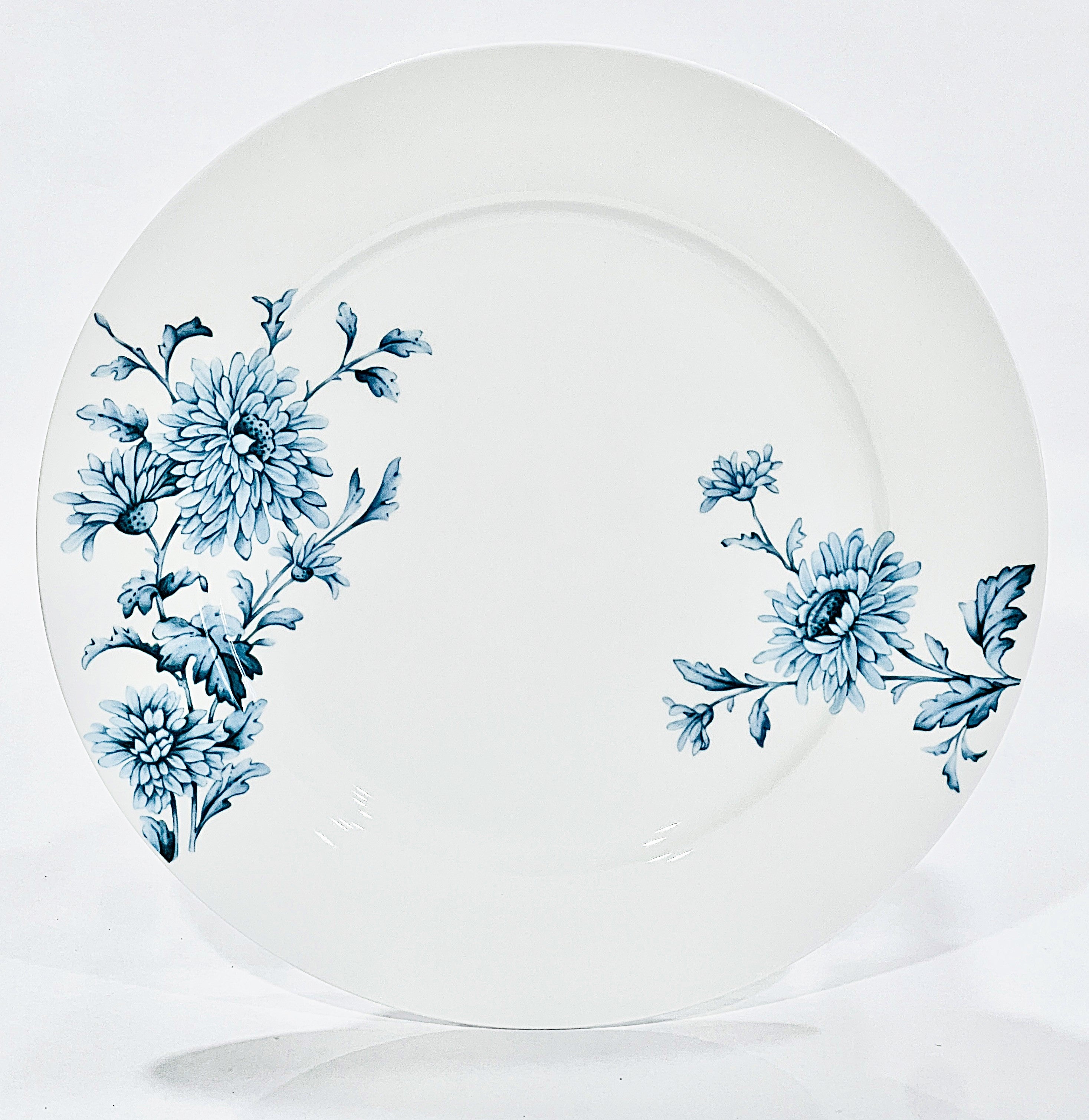 White plate with blue floral patterns on a white background