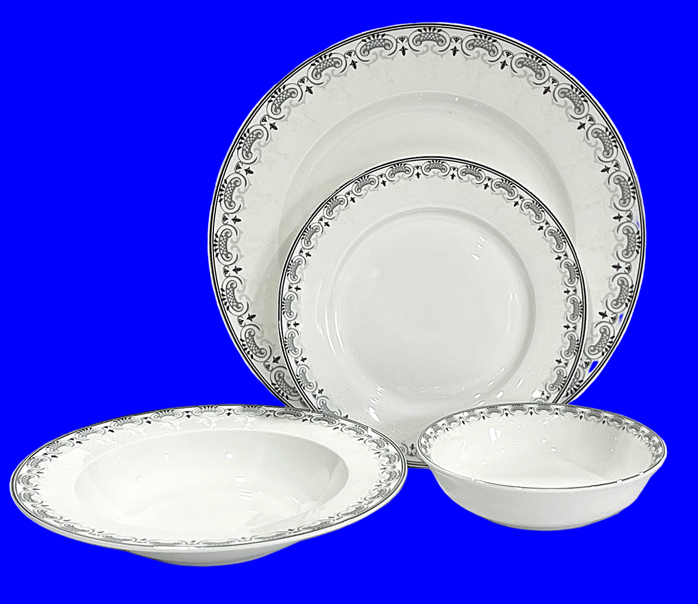 Set of white dinnerware with silver decorative rim on a white background
