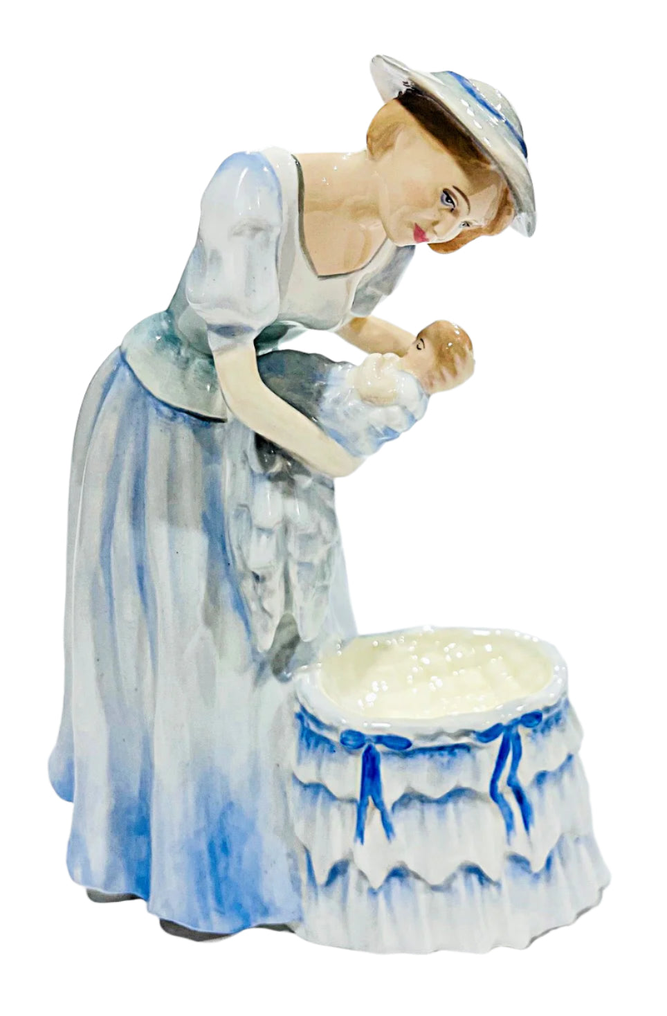 Porcelain figurine of a woman holding a baby with a white background
