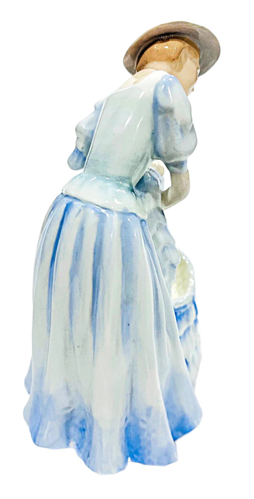 Porcelain figurine of a woman in a blue dress and hat on a white background
