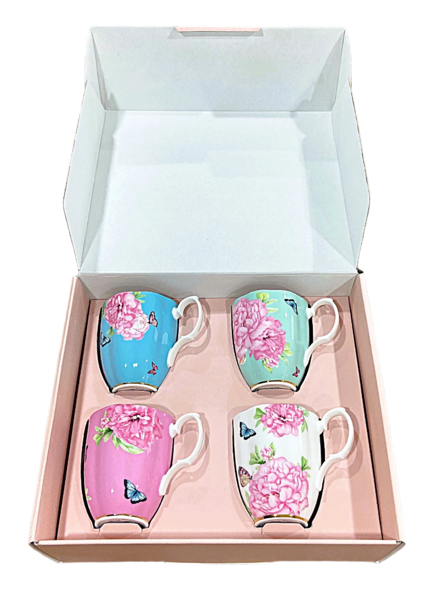 Set of four decorative mugs in a box on a marble surface